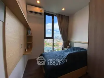 Modern bedroom with city view, featuring sleek design and natural light.