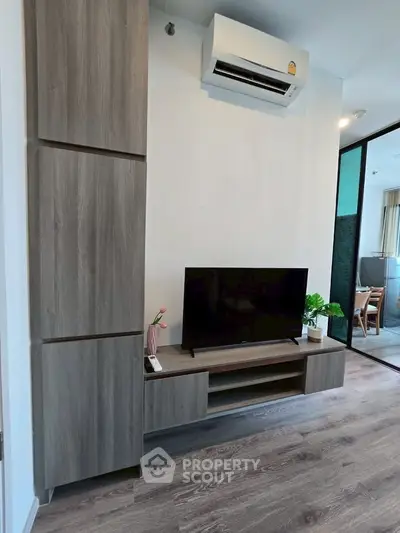 Modern living room with sleek wooden furniture and air conditioning, perfect for comfortable living.