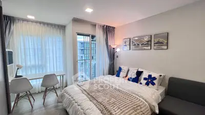 Modern bedroom with balcony access and stylish decor in a cozy apartment.