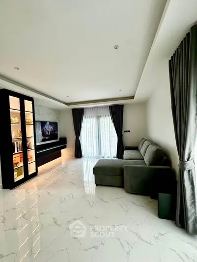 Spacious modern living room with elegant marble flooring and large window view.