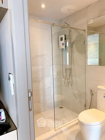 Modern bathroom with glass shower enclosure and sleek fixtures