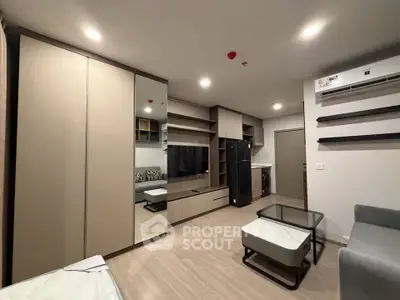 Modern living room with sleek furniture and built-in storage in a stylish apartment.