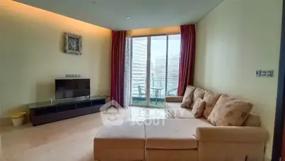 Spacious living room with modern decor and balcony view in luxury apartment.