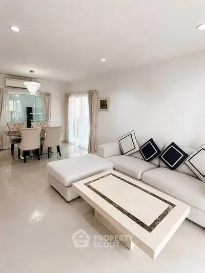 Elegant living room with modern furniture and dining area in open layout