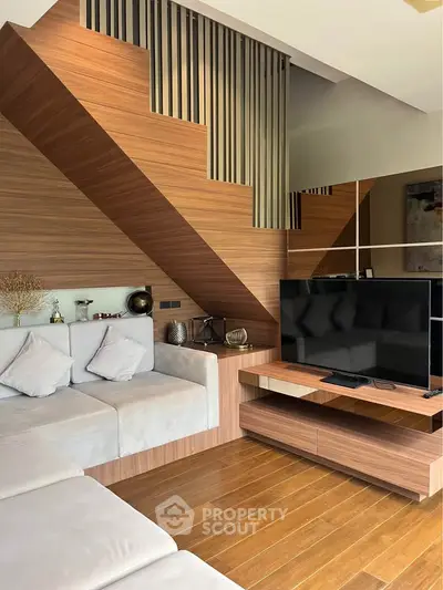 Modern living room with wooden accents and sleek TV setup
