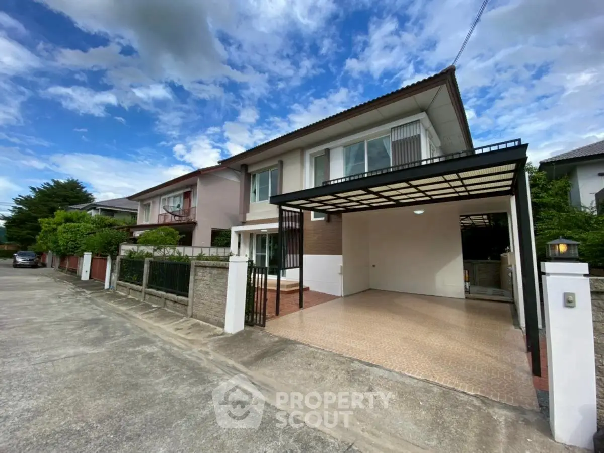 Spacious modern house with covered carport and lush surroundings in a serene neighborhood.