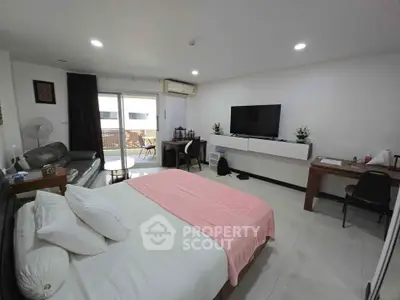Spacious bedroom with modern decor and balcony access
