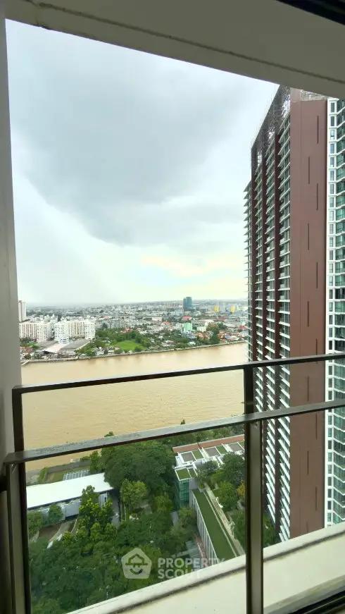 Stunning high-rise balcony view overlooking river and cityscape, perfect for urban living.