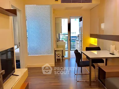 Modern apartment interior with open layout, featuring dining area and balcony access.