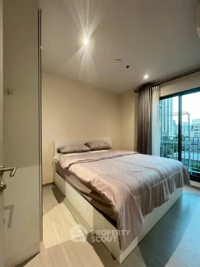 Modern bedroom with city view and balcony access in urban apartment