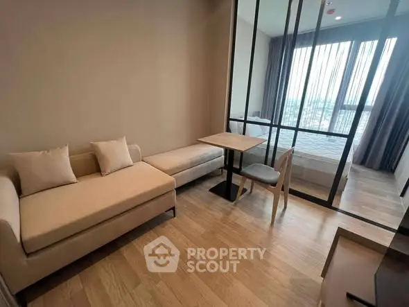 Modern living room with elegant furniture and large windows offering a stunning view.