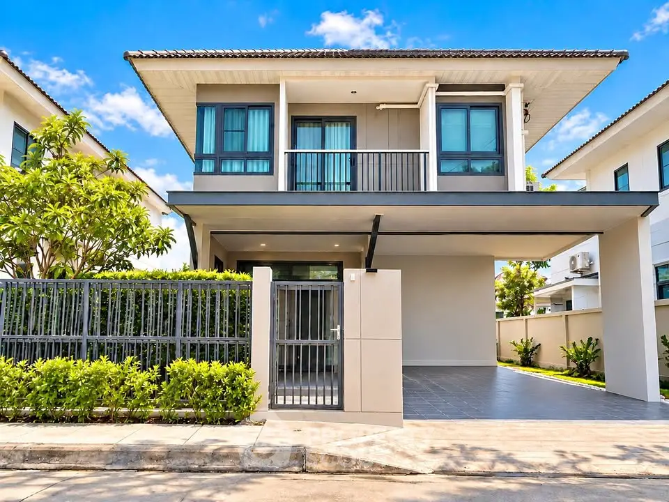 Modern two-story house with balcony and spacious driveway in a serene neighborhood.