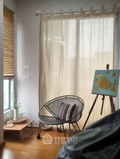 Cozy corner with modern chair and artistic decor in bright living room