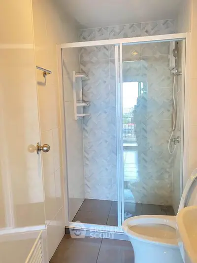 Modern bathroom with glass shower enclosure and sleek tile design