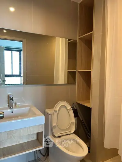 Modern bathroom with sleek fixtures and ample storage in a contemporary apartment.