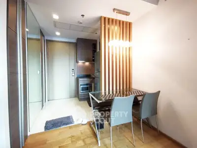Modern dining area with sleek design and wooden accents in a contemporary apartment.
