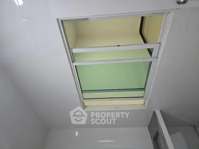 Modern bathroom ceiling with skylight window for natural light.