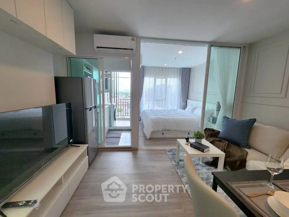 Modern studio apartment with open layout, featuring a cozy living area, sleek kitchen, and bright bedroom with balcony view.