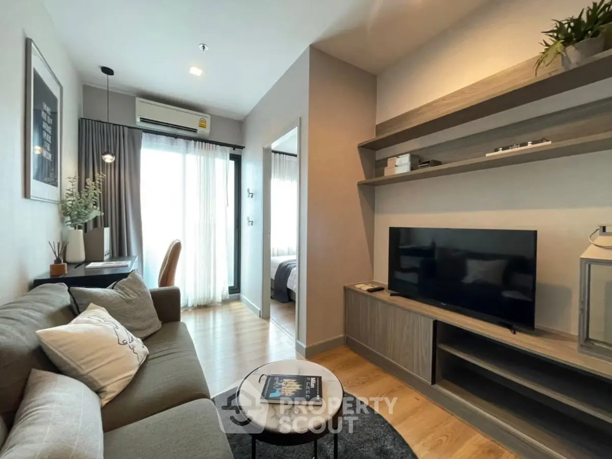 Modern living room with cozy sofa, TV, and stylish decor in a bright apartment