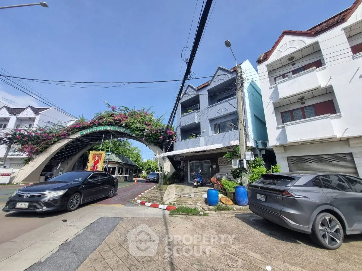 Charming residential building with unique architectural design and lush greenery in urban setting.