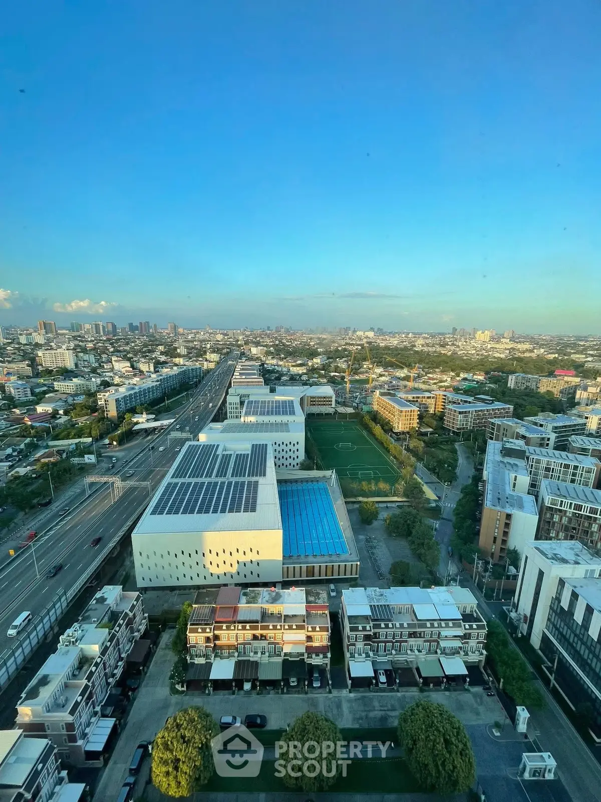 Stunning aerial view of modern urban landscape with buildings and clear blue sky.