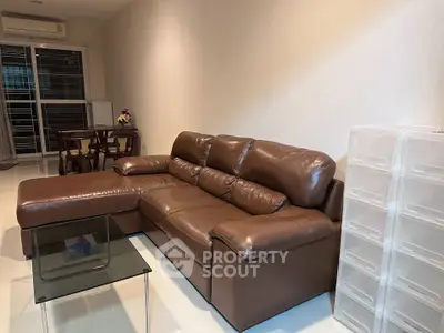 Spacious living room with leather sofa and modern decor