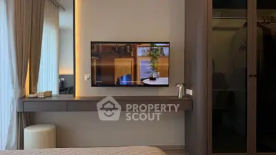 Modern bedroom with wall-mounted TV and sleek decor