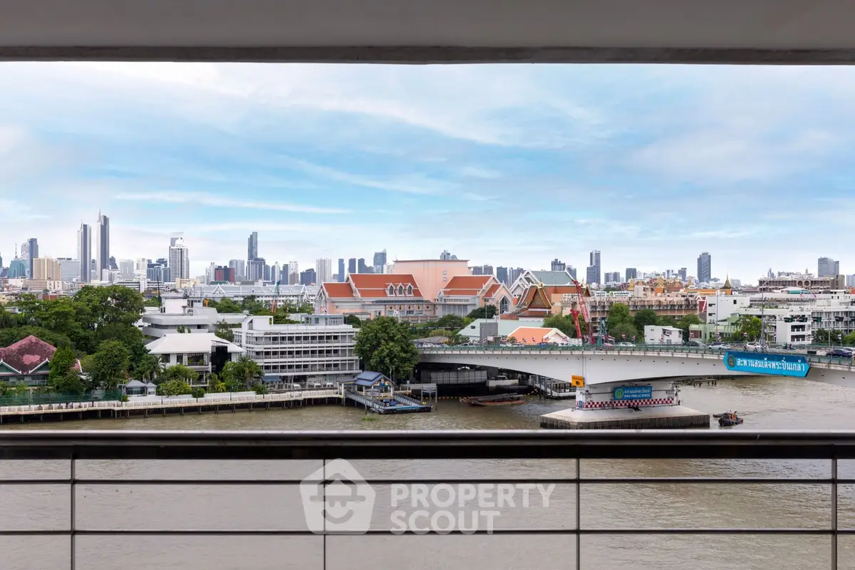 Stunning cityscape view from a balcony overlooking a river and skyline, perfect for urban living.