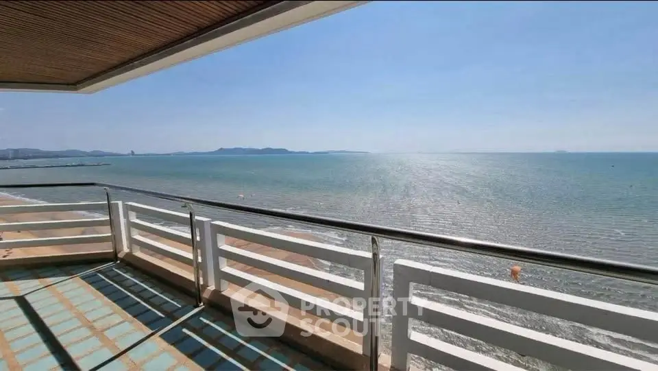 Stunning ocean view from spacious balcony in luxury seaside property.