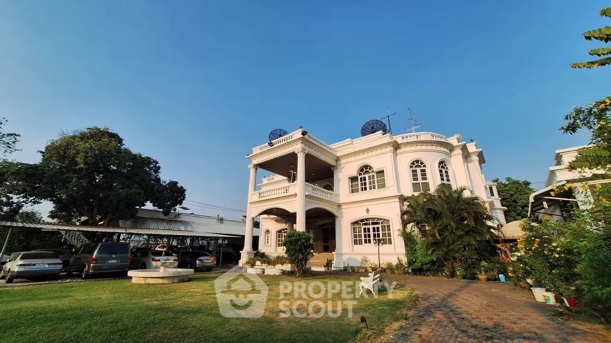 Stunning colonial-style villa with lush garden and spacious driveway, perfect for luxurious living.
