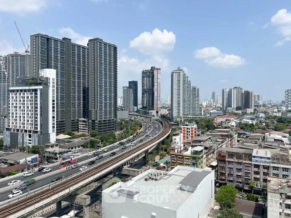 Stunning cityscape view with modern high-rise buildings and bustling highway, perfect for urban living enthusiasts.