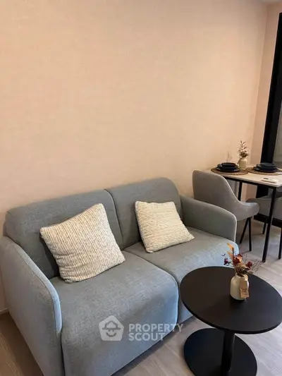 Modern living room with cozy gray sofa and stylish decor, perfect for relaxation and entertaining.