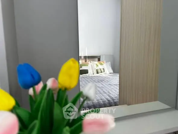 Stylish bedroom with modern decor and vibrant tulip arrangement