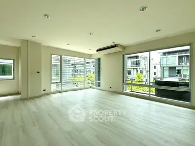 Spacious modern living room with large windows and natural light