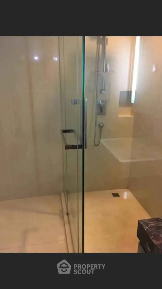 Modern bathroom with glass shower enclosure and sleek fixtures