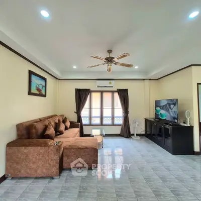 Spacious living room with cozy brown sofa and modern entertainment setup