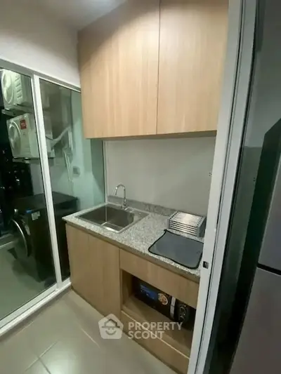 Compact kitchen with granite countertop and modern appliances