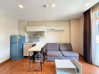 Modern studio apartment with compact kitchen and cozy living area