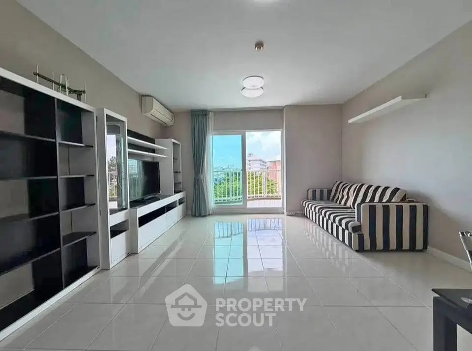 Spacious modern living room with large windows and stylish furniture