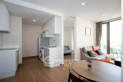Modern open-plan apartment with cozy living area and balcony view