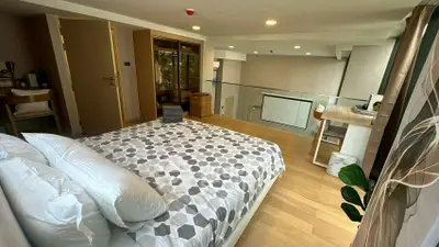 Modern bedroom with stylish decor and open layout in a contemporary apartment.