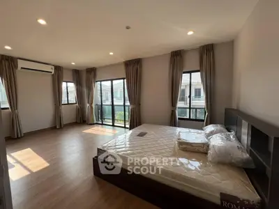 Spacious bedroom with large windows and natural light in modern home