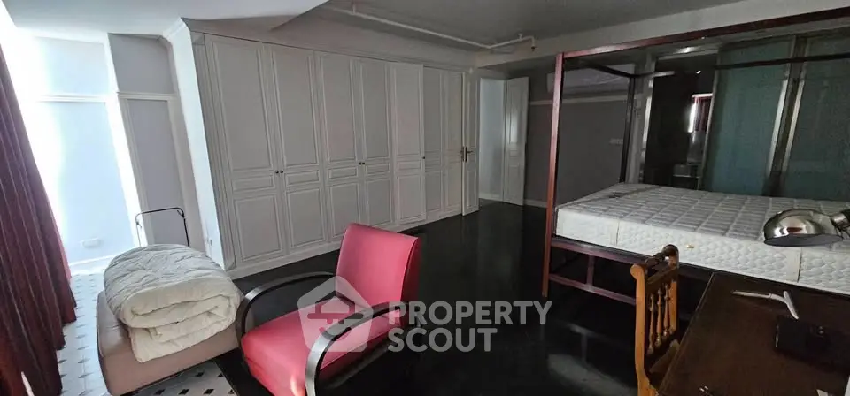Spacious bedroom with elegant wardrobe and stylish furniture, perfect for modern living.