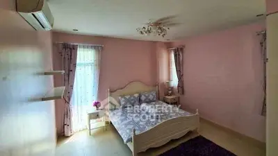 Charming bedroom with pastel pink walls and cozy bed setup