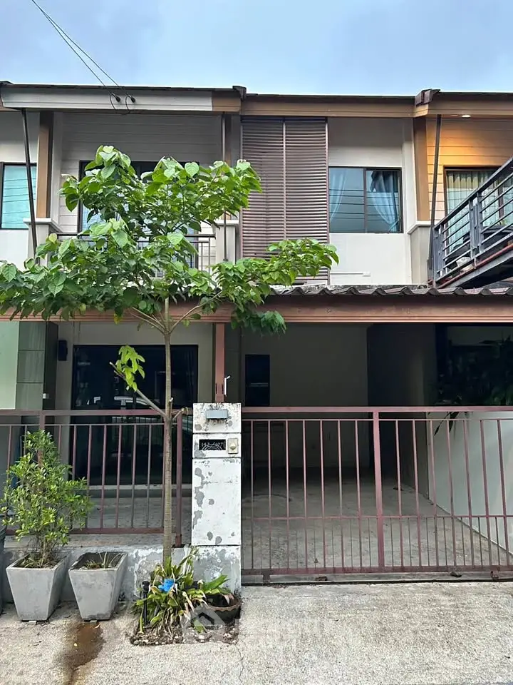 Charming townhouse with gated entrance and small garden, perfect for cozy living.