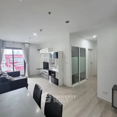 Modern living room with sleek furniture and natural light in a stylish apartment.