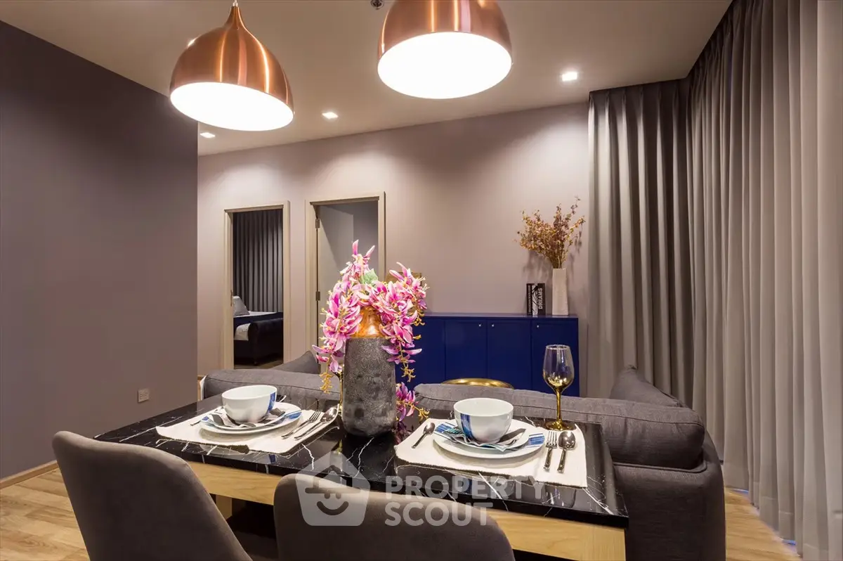 Elegant dining area with modern decor and stylish lighting in a cozy apartment.