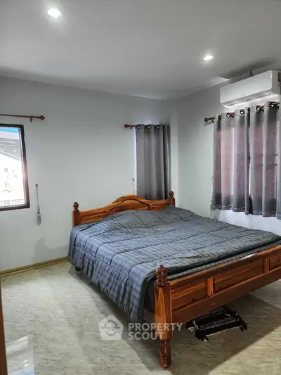 Cozy bedroom with wooden bed frame and modern decor