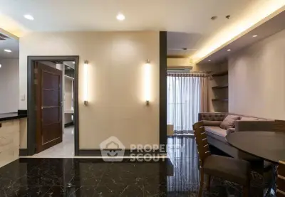 Elegant living room with marble flooring and modern lighting in a luxury apartment.