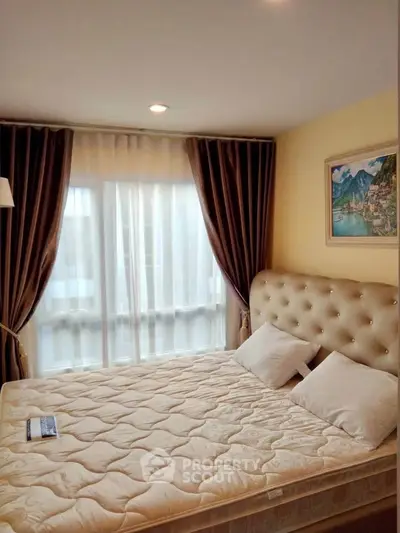 Cozy bedroom with elegant decor and large window for natural light